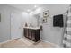 Neutral bathroom featuring double sink vanity, framed art, shower curtain, and light tile flooring at 16121 Soft Fern Trace, Odessa, FL 33556