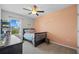 bedroom featuring ceiling fan, window with neighborhood view, area rug, and salmon colored wall at 16121 Soft Fern Trace, Odessa, FL 33556