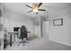 Cozy bedroom featuring a ceiling fan and workspace, creating a practical and comfortable retreat at 16121 Soft Fern Trace, Odessa, FL 33556