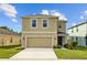 Charming two-story home featuring manicured lawn, neutral stucco, and attached two-car garage at 16121 Soft Fern Trace, Odessa, FL 33556