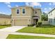 Charming two-story home featuring manicured lawn, neutral stucco, and attached two-car garage at 16121 Soft Fern Trace, Odessa, FL 33556