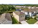 Aerial view of the home surrounded by well-manicured lawns and a pond with a fountain at 16121 Soft Fern Trace, Odessa, FL 33556