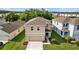 Two story tan home with a two car garage and a well maintained lawn at 16121 Soft Fern Trace, Odessa, FL 33556