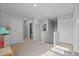 Bright hallway with neutral tones and multiple doors, offering access to different areas of the home at 16121 Soft Fern Trace, Odessa, FL 33556