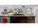 Stylish kitchen featuring stainless steel appliances, dark wood cabinets, and eat-in bar at 16121 Soft Fern Trace, Odessa, FL 33556