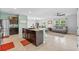 Open-concept kitchen with stainless steel appliances, dark wood cabinets, and adjacent living area at 16121 Soft Fern Trace, Odessa, FL 33556