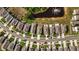 Aerial view of neighborhood featuring well-manicured lawns and a pond with a fountain at 16121 Soft Fern Trace, Odessa, FL 33556