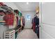 Spacious walk-in closet with organized shelving and ample storage, providing easy access to your wardrobe at 16121 Soft Fern Trace, Odessa, FL 33556