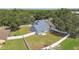 Aerial view of a charming home surrounded by mature trees and featuring a fenced backyard at 10208 Evening Trail Dr, Riverview, FL 33569