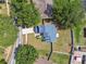 Overhead view of a property showcasing its roof, yard, surrounding trees, and proximity to the street at 10208 Evening Trail Dr, Riverview, FL 33569