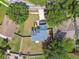 High-angle view showcasing a home's roof, yard, and its position among neighboring houses and lush trees at 10208 Evening Trail Dr, Riverview, FL 33569