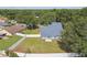 Aerial view of a single-Gathering home with a fenced backyard, mature trees, and a well-maintained lawn at 10208 Evening Trail Dr, Riverview, FL 33569