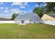 Expansive backyard with lush green lawn, blue house siding, and white fence, perfect for outdoor enjoyment at 10208 Evening Trail Dr, Riverview, FL 33569