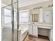 Bathroom with walk-in shower, a bath tub, a vanity sink with cabinets, and wood floors at 10208 Evening Trail Dr, Riverview, FL 33569