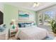 Nicely staged bedroom with bright windows, white bedding and blue accents at 10208 Evening Trail Dr, Riverview, FL 33569