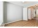 Bedroom featuring gray walls, a window, and two doors; one leading to a closet at 10208 Evening Trail Dr, Riverview, FL 33569