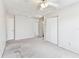 Bare bedroom featuring carpeted floors, a ceiling fan, and double door closet at 10208 Evening Trail Dr, Riverview, FL 33569