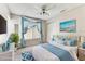 Nicely staged bedroom with a bed, turquoise curtains and decorative staging at 10208 Evening Trail Dr, Riverview, FL 33569
