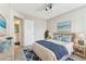 Staged bedroom featuring turquoise accessories, bed and access to ensuite bathroom at 10208 Evening Trail Dr, Riverview, FL 33569
