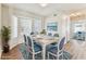 Hardwood dining room featuring a bay window, beach themed art, and neutral paint at 10208 Evening Trail Dr, Riverview, FL 33569