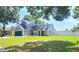 Charming two-story home with a well-manicured lawn and mature trees at 10208 Evening Trail Dr, Riverview, FL 33569