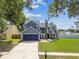 Charming two-story home with a well-manicured lawn and mature trees at 10208 Evening Trail Dr, Riverview, FL 33569
