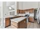 Spacious kitchen with an island, tile flooring, and stainless steel appliances at 10208 Evening Trail Dr, Riverview, FL 33569