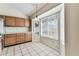 Bright kitchen nook featuring a window, tile flooring, and ample cabinet space at 10208 Evening Trail Dr, Riverview, FL 33569