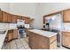 Kitchen with stainless steel appliances, an island, and tile flooring at 10208 Evening Trail Dr, Riverview, FL 33569