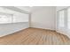 Empty room with stylish laminate flooring and clerestory windows offering an abundance of light at 10208 Evening Trail Dr, Riverview, FL 33569