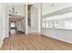 Bright, open living area with wood flooring, staircase, and lots of natural light at 10208 Evening Trail Dr, Riverview, FL 33569