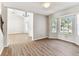 Open living room boasts hardwood floors, high ceilings, a modern chandelier, and large bay windows at 10208 Evening Trail Dr, Riverview, FL 33569