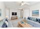 Staged living room with couches, a coffee table, television, and light wood floors at 10208 Evening Trail Dr, Riverview, FL 33569