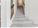 Carpeted staircase with wood railing provides access to the upper level at 10208 Evening Trail Dr, Riverview, FL 33569