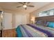 Bedroom featuring wood floors, ceiling fan, and a large closet for ample storage at 10623 103Rd St, Largo, FL 33773