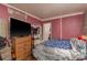 Messy bedroom with a bed, dresser, and TV at 10623 103Rd St, Largo, FL 33773