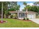 Charming single-story home with well-maintained landscaping and inviting screened entrance at 10623 103Rd St, Largo, FL 33773