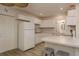 Bright kitchen featuring white cabinets, breakfast bar, and stainless steel appliances at 10623 103Rd St, Largo, FL 33773