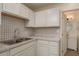 Corner of a bright kitchen featuring white cabinets and stylish backsplash at 10623 103Rd St, Largo, FL 33773