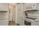Close-up of kitchen showcasing white cabinets, backsplash, and stainless steel appliances at 10623 103Rd St, Largo, FL 33773