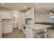 Bright kitchen features white cabinets, stainless appliances, and an island with seating at 10623 103Rd St, Largo, FL 33773