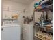 Functional laundry room with modern washer, dryer, and storage shelving at 10623 103Rd St, Largo, FL 33773