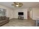 Open living area with wood-look flooring and a stylish ceiling fan at 10623 103Rd St, Largo, FL 33773
