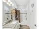 Bright bathroom with double sinks and granite countertop, framed mirror and shower and tub combo at 10669 Cardera Dr, Riverview, FL 33578