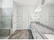 Bathroom features double sinks, granite countertops, and walk-in shower at 10669 Cardera Dr, Riverview, FL 33578