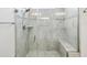 Modern bathroom with a glass shower featuring elegant tile work and a built-in bench at 10669 Cardera Dr, Riverview, FL 33578