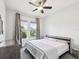 Bedroom with a ceiling fan, two windows with curtains, and neutral wall color at 10669 Cardera Dr, Riverview, FL 33578