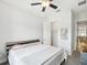 Bedroom featuring grey headboard, a white bed spread and carpet and a ceiling fan with light at 10669 Cardera Dr, Riverview, FL 33578
