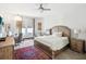 Inviting bedroom with large window, ceiling fan, and comfortable furnishings at 10669 Cardera Dr, Riverview, FL 33578