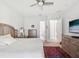 Cozy bedroom featuring ceiling fan, neutral decor, and a dresser at 10669 Cardera Dr, Riverview, FL 33578